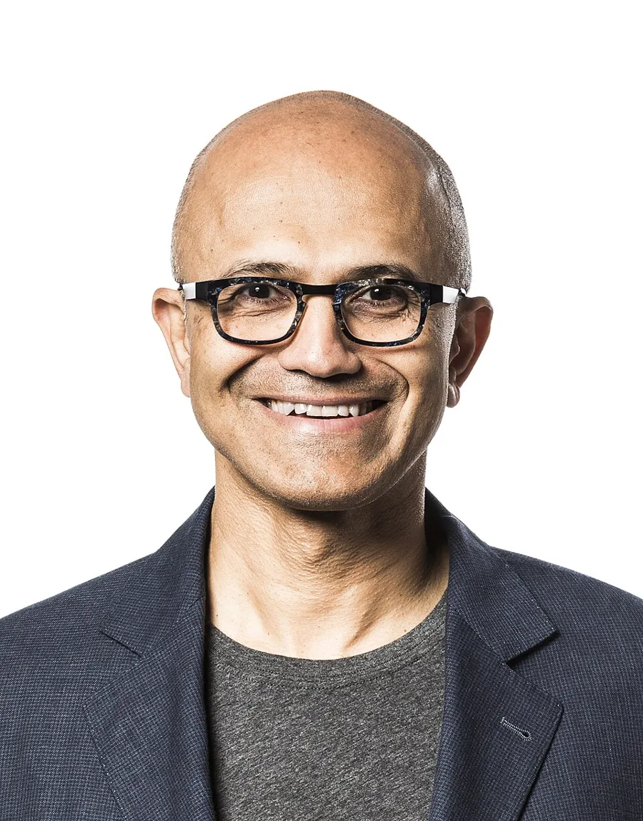 Satya Nadella, chairman and chief executive of Microsoft, smiling in glasses and a dark jacket