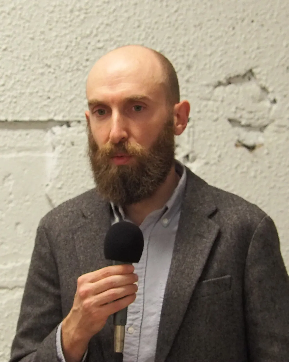 Andy Greenberg of WIRED, speaking into a microphone